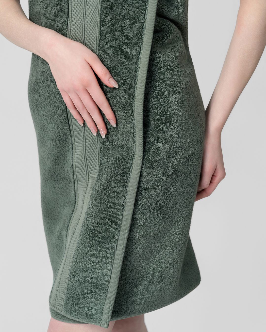 person wrapped in a green modal cotton bath towel that sits smooth against the skin