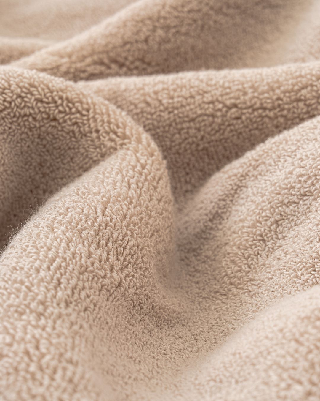 close up of beige modal cotton terry showing the fine, soft loop texture
